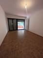 empty room, wooden floor, sliding glass door, white walls, white radiator, ceiling light