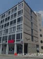 The building features modern architecture, multiple floors, large windows, and a flat facade.
