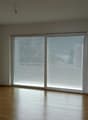 empty room, white walls, wooden floor, large sliding glass doors