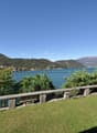 Green lawn, lake in background, mountains