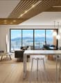 Large windows with views, modern decor, leather sofa, coffee table, television, floor lamp