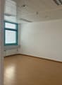 empty office room, windows, wooden floor, radiator