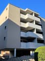 modern apartment building, balconies, 4 stories, basement parking, concrete balcony structures