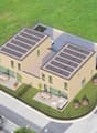 Two story building with solar panels on the roof, car park and seating area
