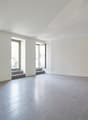 Empty room, tile floor, 2 windows, doorways