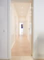 corridor, white walls, white ceiling, hardwood floor, recessed ceiling lights