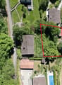House on elevated plot, surrounded by trees, pool in the corner