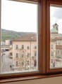View from the window to the outside buildings and a road, a person walking