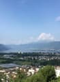 Aerial view of mountains, lake, and city.