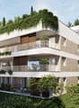 3-story modern apartment building with white exterior, wooden accents, and balconies. The building is surrounded by lush greenery and trees.
