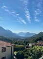 hilltop view of mountains and a lake in the distance