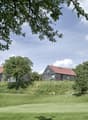 2 houses on hill, red roofs, modern design, green surroundings, golf course