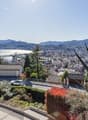 House with garage, driveway, garden, view of mountains and city