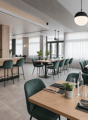 modern interior design, wooden tables and chairs, white curtains, plants, glass bottle, light fixtures, counter with bar stools