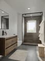 modern bathroom, white countertop, wooden cabinet, glass shower, wooden bench, tiled floor