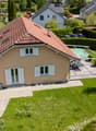 Single family house, red roof, brown exterior, garden, swimming pool, covered terrace, multiple windows, hedges, driveway