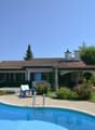 Modern house with swimming pool, outdoor seating, well-kept garden