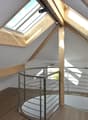 attic room with spiral staircase and skylight