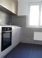 gray tile wall, blue tile floor, white cabinet, electric stove, window, radiator