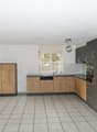 kitchen with wooden cabinets, sink, dishwasher, tile floor, and window with white blinds
