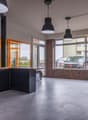 modern kitchen with black cabinets, countertop, sink, faucet, large windows, tiled floor, hanging lamps