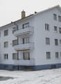 3 story white building, balcony, chimney, windows, snow