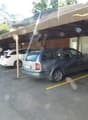 outdoor car park covered by a roof, cars parked