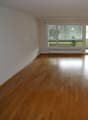 empty room, wooden floor, white walls, sliding glass doors, balcony