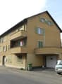 3 story house, beige paint, balconies, garage