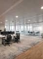 open office space, modern office furniture, office tables, chairs, glass walls, glass doors, plants
