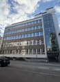 modern office building with glass windows, glass entrance, 4 parking spaces