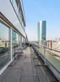 Balcony with benches, glass walls, city view