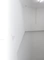 Empty room, white walls, gray floor, transport trolley, 24/7 access