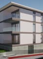 3-story modern apartment building with a flat roof, large windows, and a balcony on the upper floors. The building has a clean, minimalist design with a combination of light and dark colors.