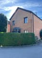 2 story house, brick exterior, 3 windows, glass doors, chimney