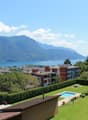 Building with a view of the city and mountains, swimming pool, and a lake