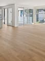 Open floor plan, modern kitchen, hardwood floors, kitchen island, glass sliding doors, balconies, panoramic city view
