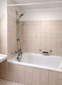 Bathroom with bathtub, sink, mirror, shower curtain, towel rack