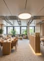 Lighting from ceiling and wall, couches, massage tables, tables, chairs, plants