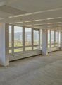Empty room, large windows, overlooking a golf course
