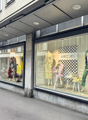 A building with a shop on the ground floor, glass windows, and a signboard with the text 'MARCAIN'.