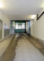 concrete floor, white walls, glass panels, lights on the ceiling