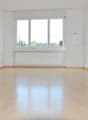 empty room, wooden floor, white walls, large window, white radiator