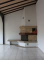 tiled floor, fireplace, white walls, ceiling lights, window