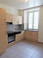 modern kitchen, tiled floor, wooden cabinets, stainless steel appliances, double sink, window