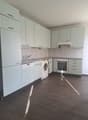 Modern kitchen with wooden cabinets, granite countertops, integrated dishwasher and washing machine, stainless steel appliances, tiled backsplash