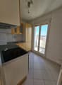 kitchen with appliances, countertop, sink, cabinets, balcony