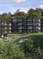 Modern apartment building with multiple floors, balconies, and green spaces