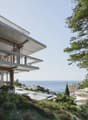 Modern house, concrete structure, glass windows, elevated position, sea view