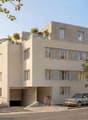 4 story building, beige exterior, multiple windows, garage, balcony on top floor